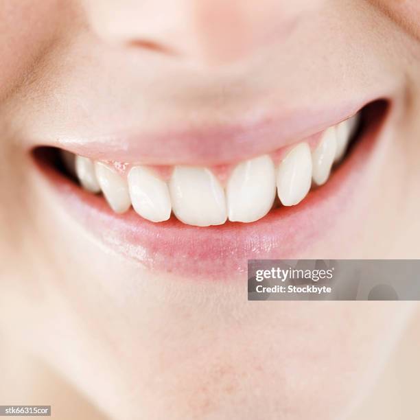 close-up of a woman's toothy smile - smile stockfoto's en -beelden