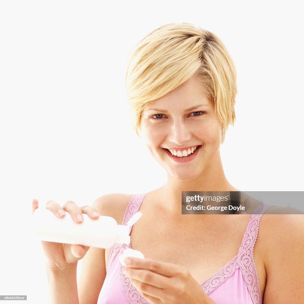 Portrait of a woman poring out lotion onto cotton wool
