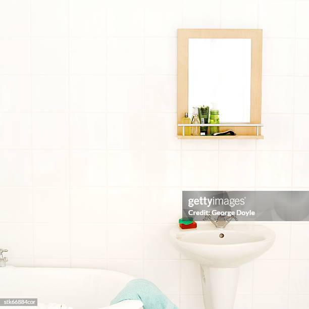 view of a basin and cabinet inside a bathroom - inside of ストックフォトと画像