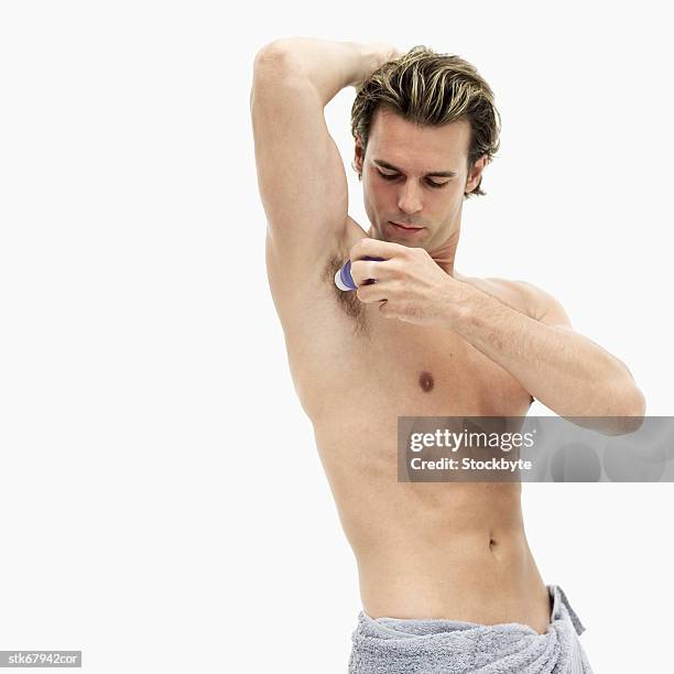 man using a roll on deodorant - roll on bildbanksfoton och bilder