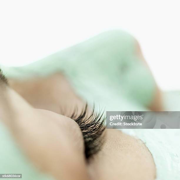 close-up of a woman wearing a face mask - wearing stock-fotos und bilder