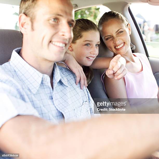 side profile of young parents in a car with their daughter in the backseat - in profile stock pictures, royalty-free photos & images