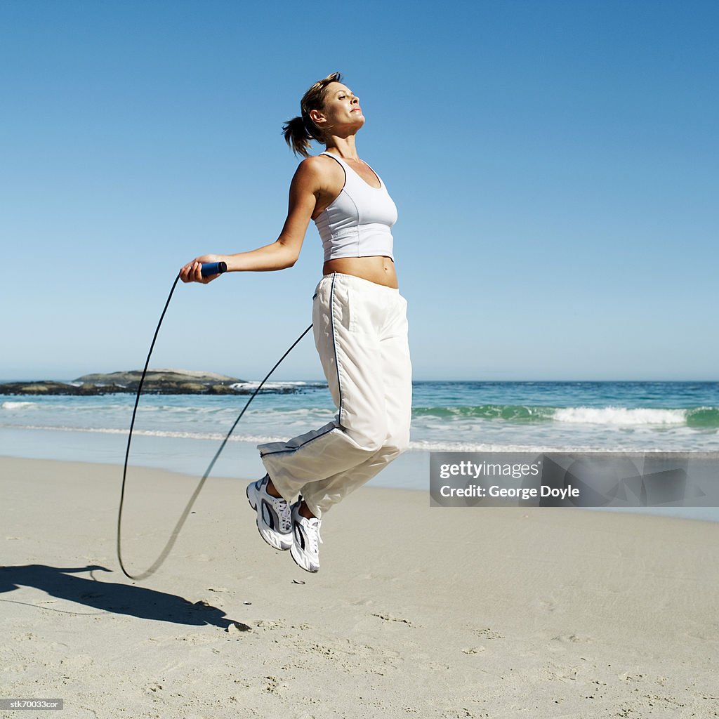 Portrait Of A Young Woman Skipping Rope On The Beach High-Res Stock