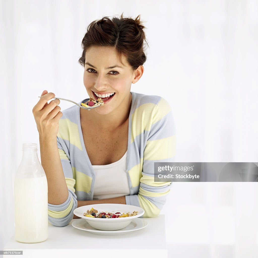 Portrait of a woman eating breakfast cereal