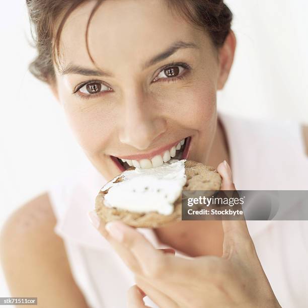 portrait of woman smiling biting a cracker with cheese - taste of john paul ataker presentation spring 2016 new york fashion week stockfoto's en -beelden