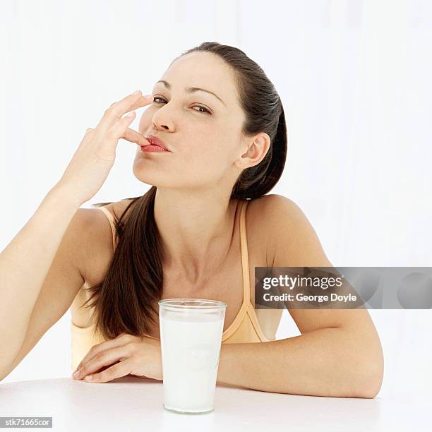 portrait of a woman tasting milk with her finger - taste of john paul ataker presentation spring 2016 new york fashion week stockfoto's en -beelden