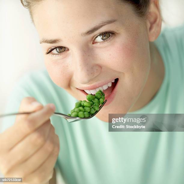 close-up of a woman eating peas with a fork - magnoliopsida bildbanksfoton och bilder
