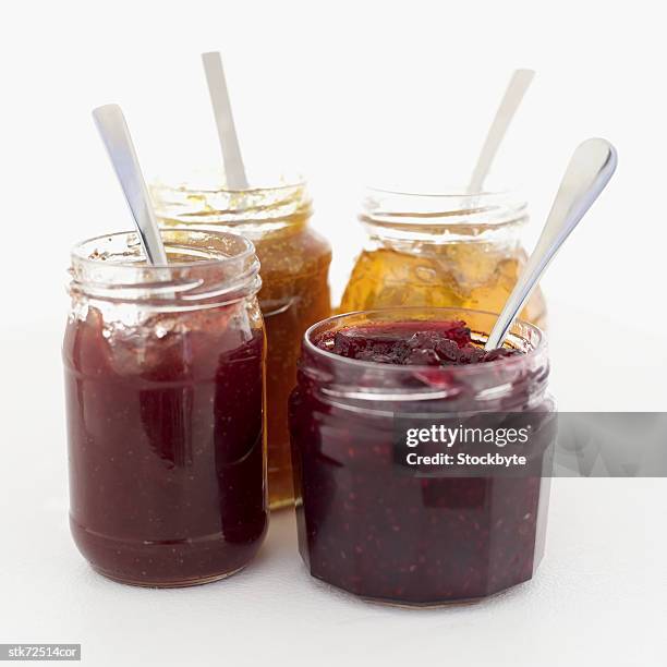 assorted jams in jars with a spoon - raspberry jam stock pictures, royalty-free photos & images