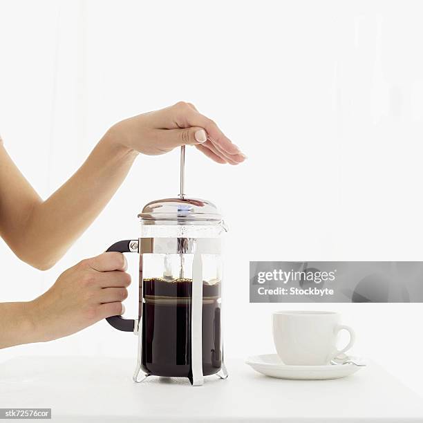 woman using a coffee plunger - using stock pictures, royalty-free photos & images