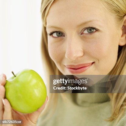 Portrait of a woman holding a green apple Portrait of a woman holding a green apple