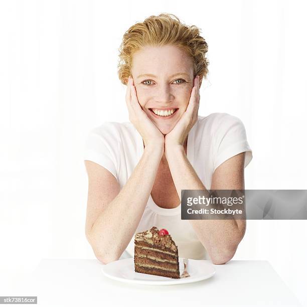 portrait of a woman with a slice of cake on a plate - slice stock pictures, royalty-free photos & images