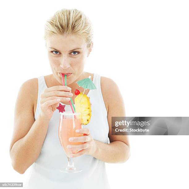 woman drinking a cocktail with a straw - drinks utensil stock pictures, royalty-free photos & images