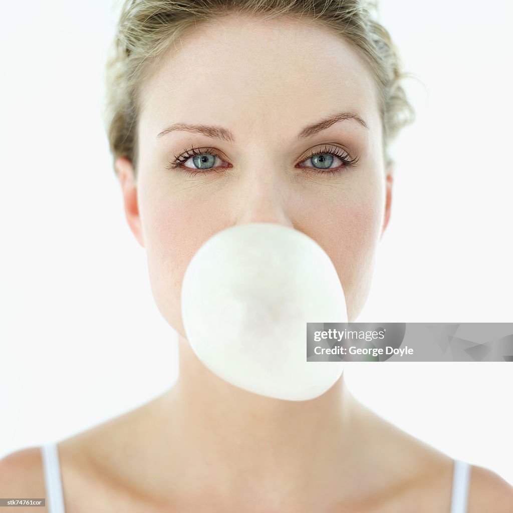 Woman blowing a chewing gum bubble