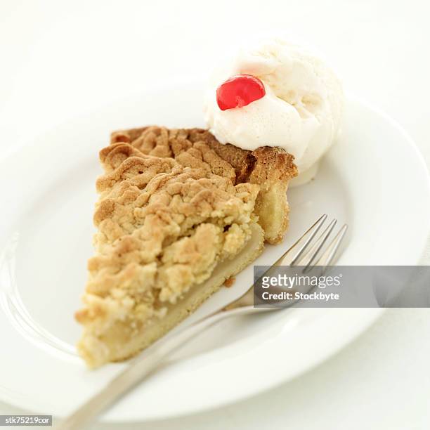close-up of a slice of pie with ice cream and a cherry garnish - slice stock pictures, royalty-free photos & images