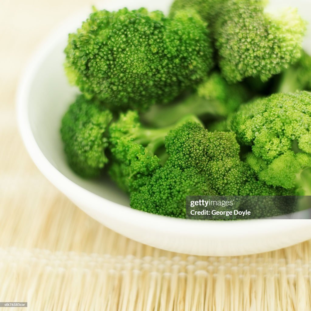Close-up of a bowl of cut pieces of broccoli