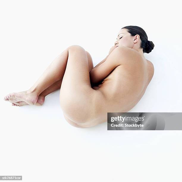 elevated view of a nude woman - hugging knees stock pictures, royalty-free photos & images