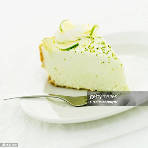 close-up of a slice of lemon cheesecake - slice stock pictures, royalty-free photos & images