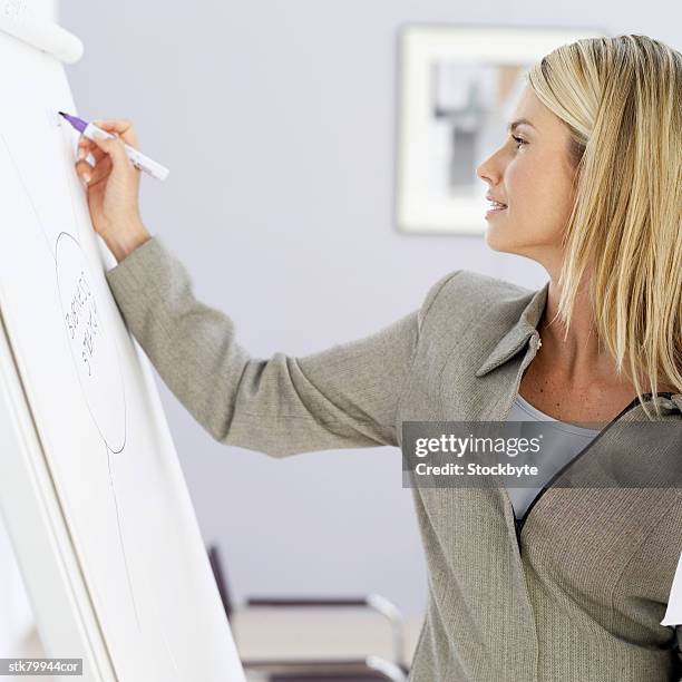 businesswoman writing on a white board - presentation of the book scenes de crime au louvre written by christos markogiannakis in paris stockfoto's en -beelden