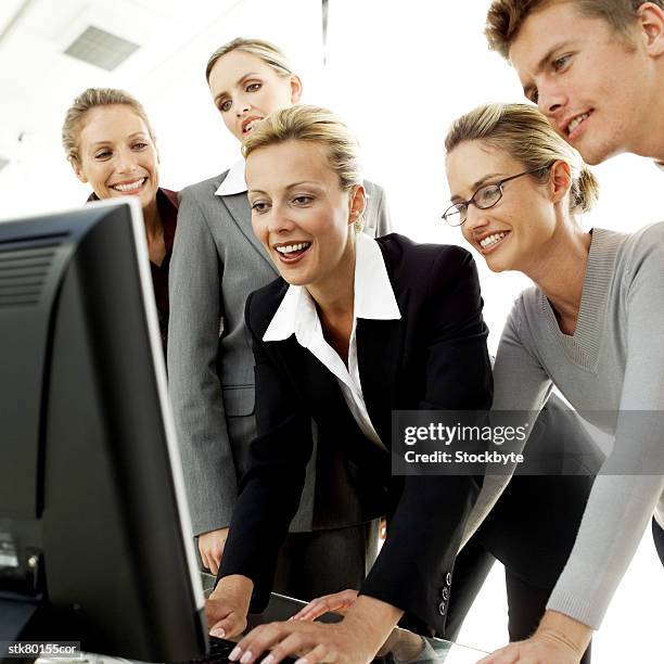 a group of young business executives viewing a computer screen together - informational stock pictures, royalty-free photos & images