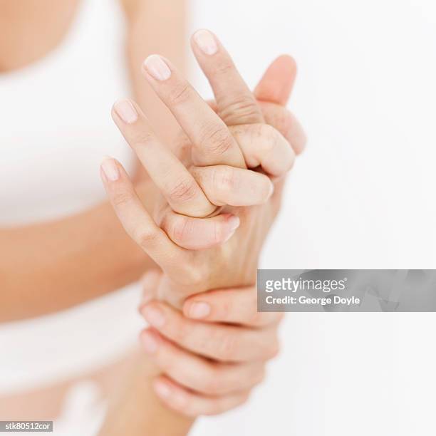 close up of a masseuses' hands massaging a persons hand - human joint stock pictures, royalty-free photos & images