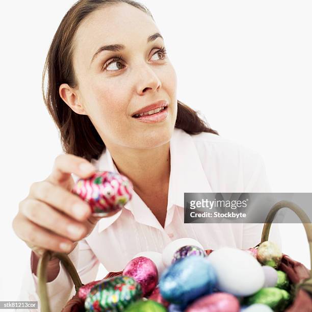 woman stealing an easter egg - caught in the act fotografías e imágenes de stock