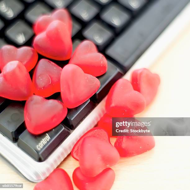 close-up of heart shaped candy on a computer keyboard - house and senate dems outline constitutional case for trump to obtain congressional consent before accepting foreign payments or gifts fotografías e imágenes de stock