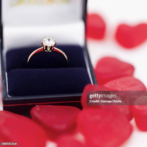 close-up of an engagement ring surrounded by heart shaped candy - house and senate dems outline constitutional case for trump to obtain congressional consent before accepting foreign payments or gifts fotografías e imágenes de stock