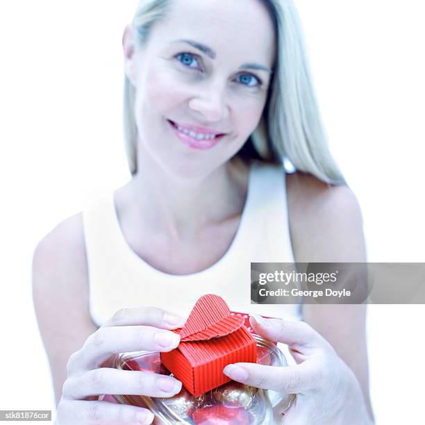 portrait of a young woman opening a little red box - house and senate dems outline constitutional case for trump to obtain congressional consent before accepting foreign payments or gifts fotografías e imágenes de stock