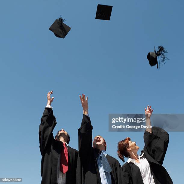 low angle view of graduates throwing their caps up - gov scott visits miami school in zika cluster zone on first day of classes stockfoto's en -beelden