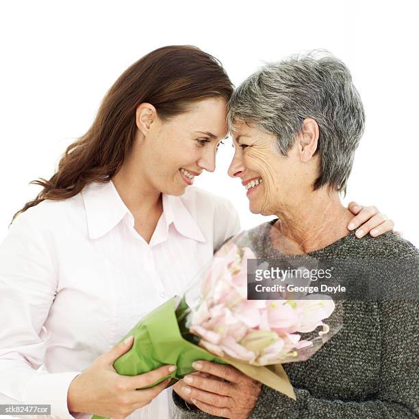 portrait of a mother and daughter holding a bouquet of flowers - house and senate dems outline constitutional case for trump to obtain congressional consent before accepting foreign payments or gifts stock pictures, royalty-free photos & images