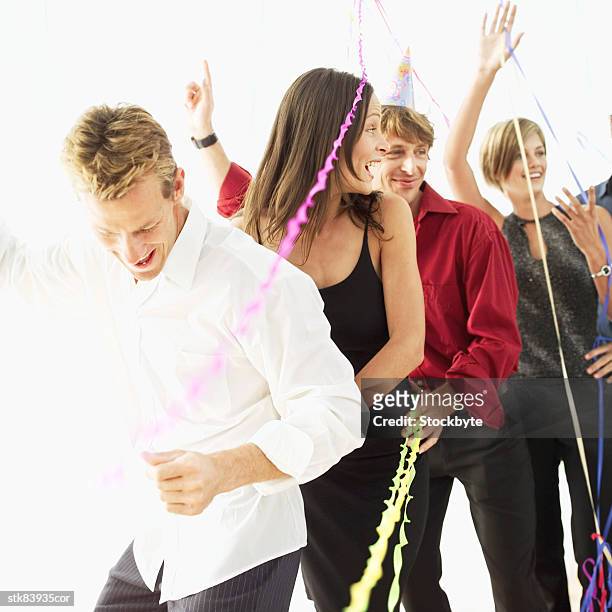 men and women doing the conga at a party - duing stock pictures, royalty-free photos & images