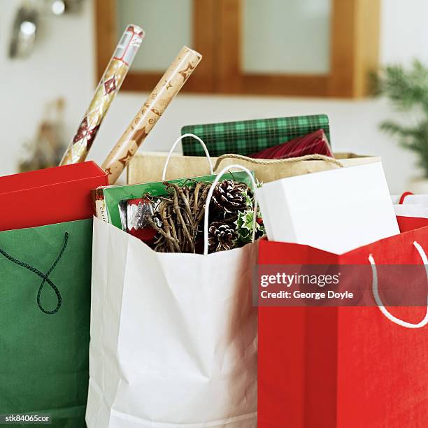 close-up of christmas gifts and wrapping paper in shopping bags - house and senate dems outline constitutional case for trump to obtain congressional consent before accepting foreign payments or gifts fotografías e imágenes de stock