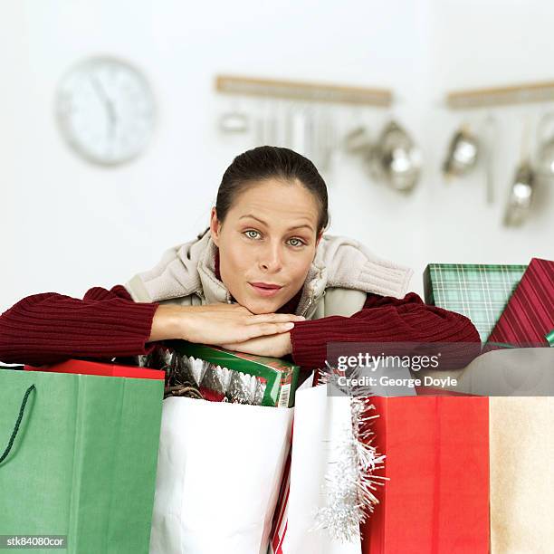portrait of a young woman leaning on christmas shopping - house and senate dems outline constitutional case for trump to obtain congressional consent before accepting foreign payments or gifts fotografías e imágenes de stock