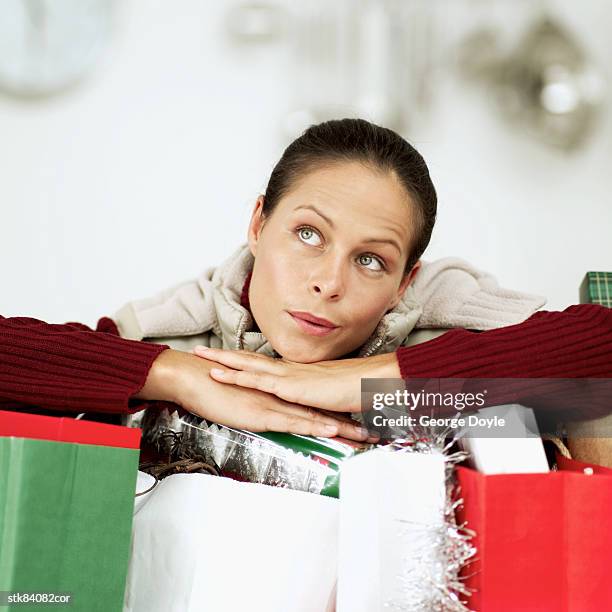 woman leaning over christmas gifts - house and senate dems outline constitutional case for trump to obtain congressional consent before accepting foreign payments or gifts fotografías e imágenes de stock