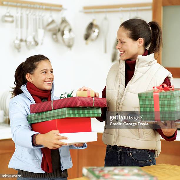 portrait of a mother and daughter carrying christmas gifts - house and senate dems outline constitutional case for trump to obtain congressional consent before accepting foreign payments or gifts fotografías e imágenes de stock