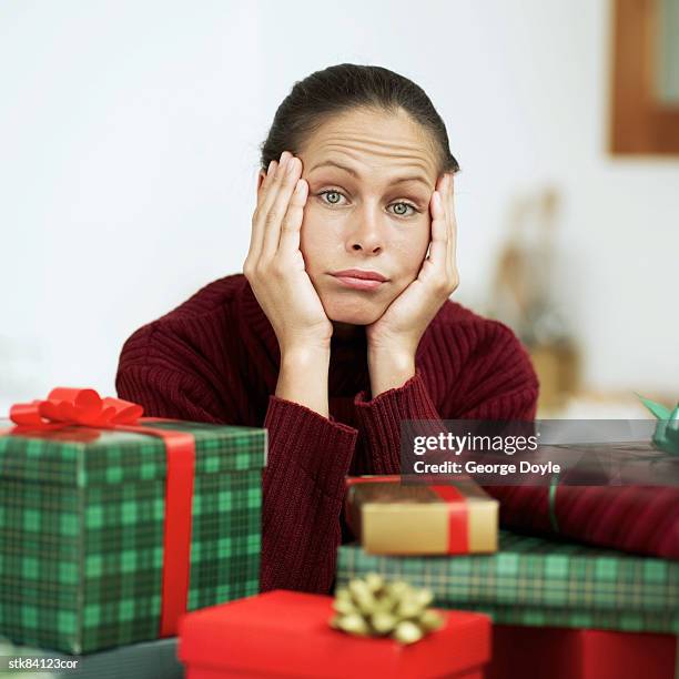 disillusioned woman at christmas - house and senate dems outline constitutional case for trump to obtain congressional consent before accepting foreign payments or gifts fotografías e imágenes de stock