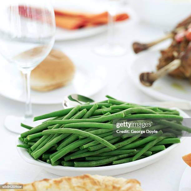 a dish of green beans on a dinner table - magnoliopsida bildbanksfoton och bilder