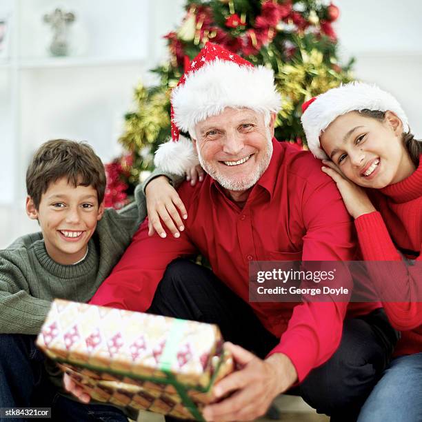 grandfather and grandchildren (8-13) at christmas - house and senate dems outline constitutional case for trump to obtain congressional consent before accepting foreign payments or gifts fotografías e imágenes de stock