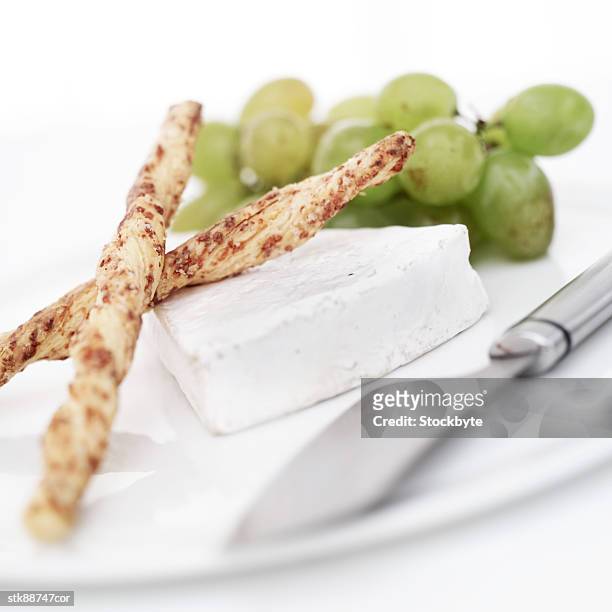 close-up of bread sticks and a slice of cottage cheese on a plate - slice stock pictures, royalty-free photos & images