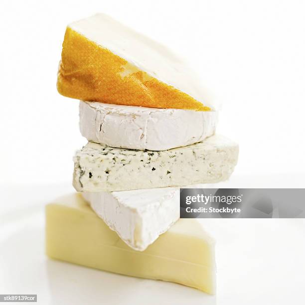 close-up of assorted cheeses piled one on top of the other - other stock-fotos und bilder