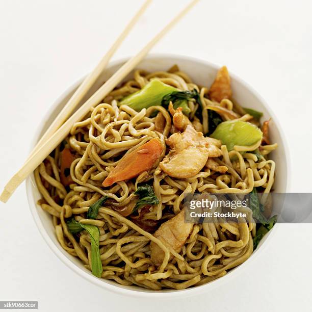 high angle view of chinese noodles in a bowl and a pair of chopsticks - gen z studio brats premiere of chicken girls arrivals stockfoto's en -beelden