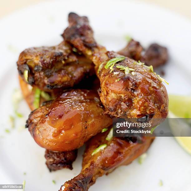 close-up of barbequed chicken legs - gen z studio brats premiere of chicken girls arrivals stockfoto's en -beelden