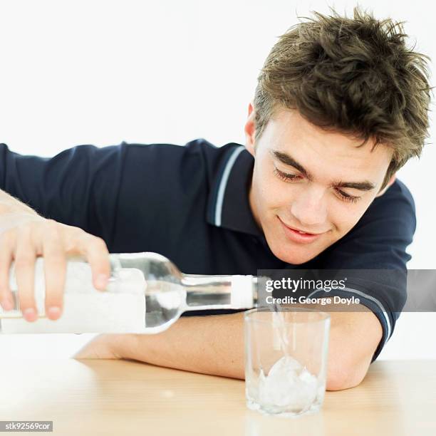 teenage boy (16-17) vodka into a glass - only teenage boys stock pictures, royalty-free photos & images