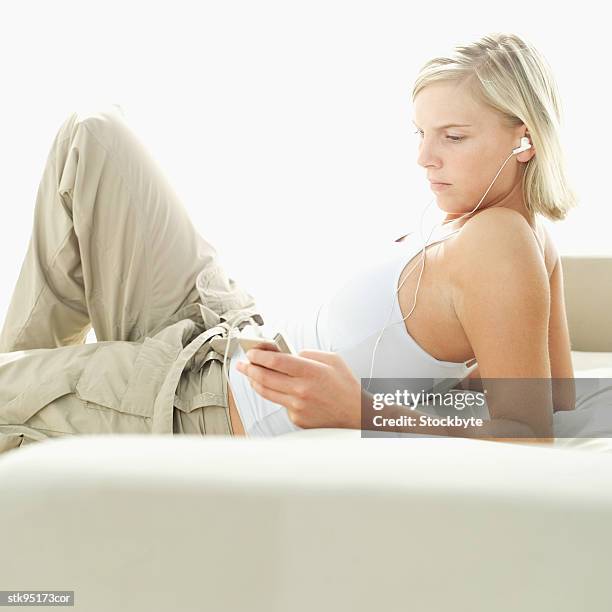 woman listening to an mp3 player - audio electronics stock pictures, royalty-free photos & images