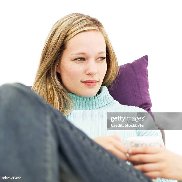 portrait of a young blonde woman holding a mug - square neckline fotografías e imágenes de stock