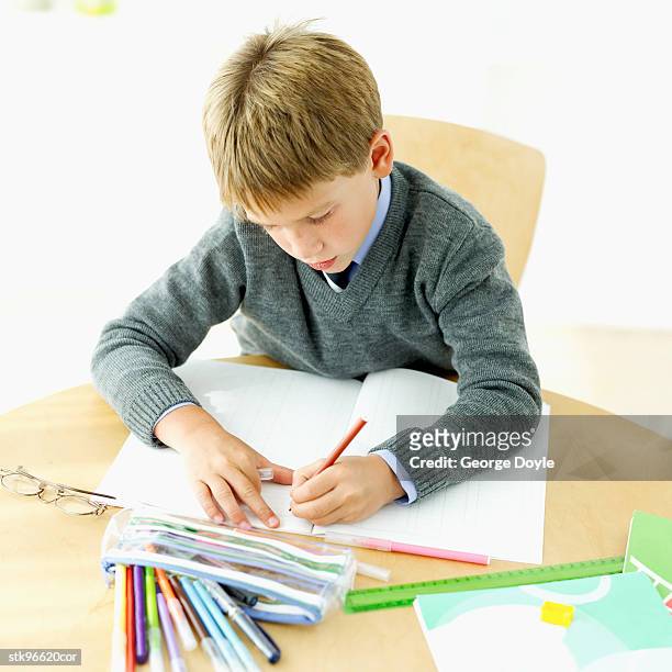 boy (6-7) doing his homework - donald trump holds campaign rally in nc one day ahead of primary stockfoto's en -beelden