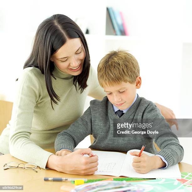 portrait of a young boy being tutored by his teacher - donald trump holds campaign rally in nc one day ahead of primary stockfoto's en -beelden