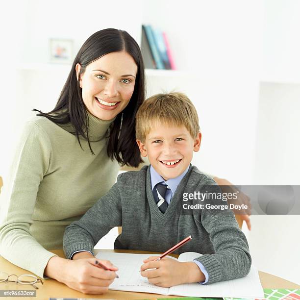 portrait of a mother and son (6-7) doing homework together - duing stock pictures, royalty-free photos & images