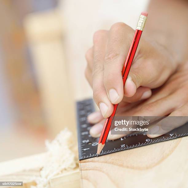 close-up of hands marking measurements with a pencil - unknown gender stock pictures, royalty-free photos & images