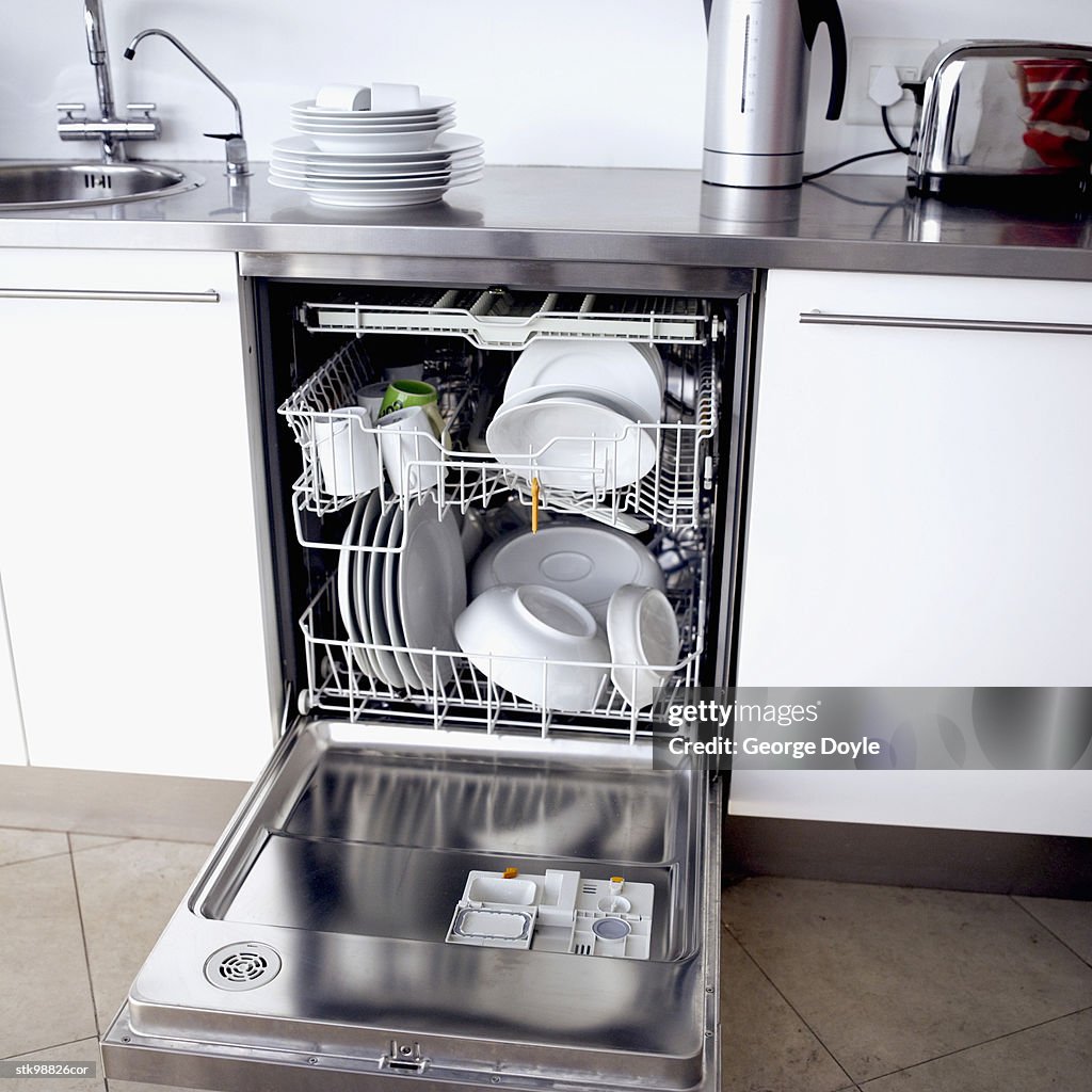 Close-up of a dishwasher filled dishes